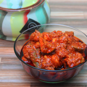 A bowl of homemade mango pickle made from raw mangoes and spices, ready to be enjoyed with rice or bread.