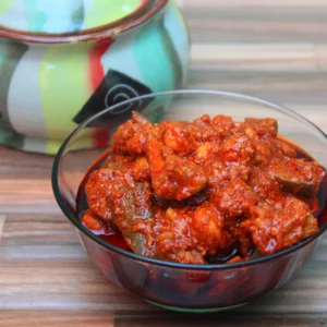 A bowl of homemade mango pickle made from raw mangoes and spices, ready to be enjoyed with rice or bread.