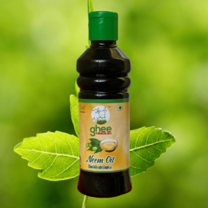 A bottle of neem oil with a black body and green cap, labelled with "ghee" and "Neem Oil", set against a blurred green leaf background.